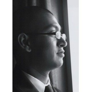 Profile of man in glasses gazing out window.