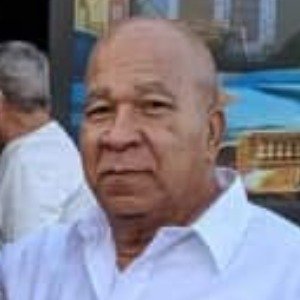 Elderly man in a white shirt outdoors