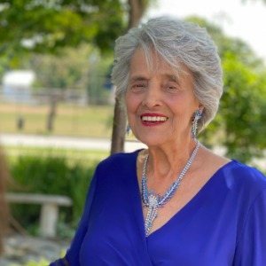 Smiling woman in blue dress outdoors