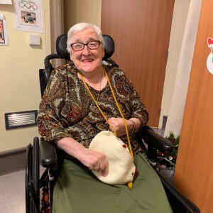 Elderly woman smiling in a wheelchair