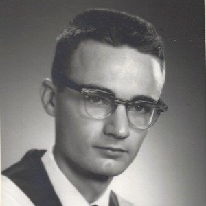 Black and white portrait of man with glasses.