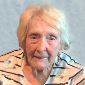 Elderly woman smiling in striped shirt