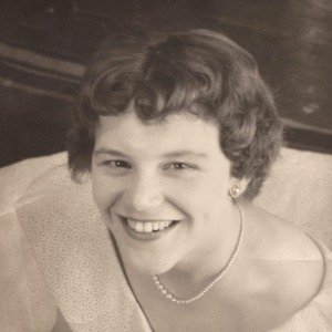 Smiling woman in vintage dress and pearls photo