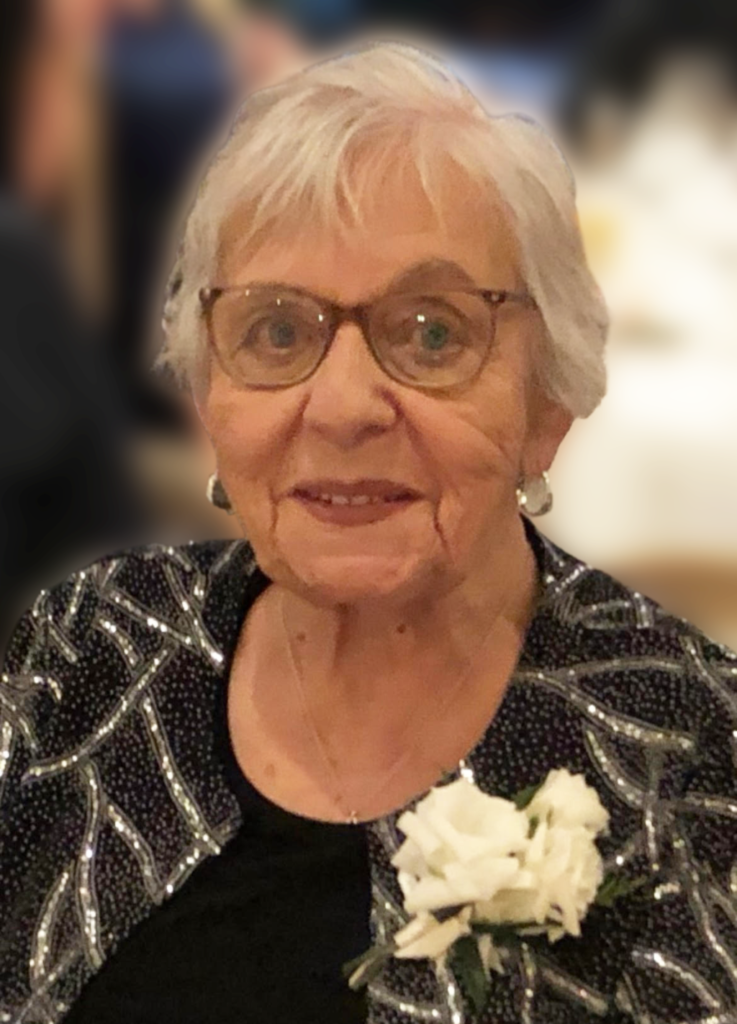 Elderly woman with glasses and a white flower