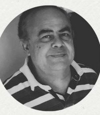 Smiling person in striped shirt, grayscale photo.