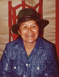 Smiling person wearing hat and blue jacket