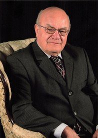Elderly man in suit sitting on chair