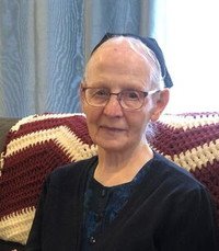 Elderly woman sitting on a chair indoors