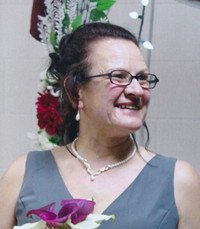 Smiling woman holding flowers at an event