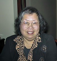 CHAN, Ah Lan Linda Chan Smiling person in glasses and patterned blouse.