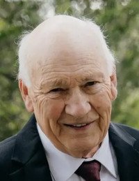 Elderly man smiling in suit outdoors