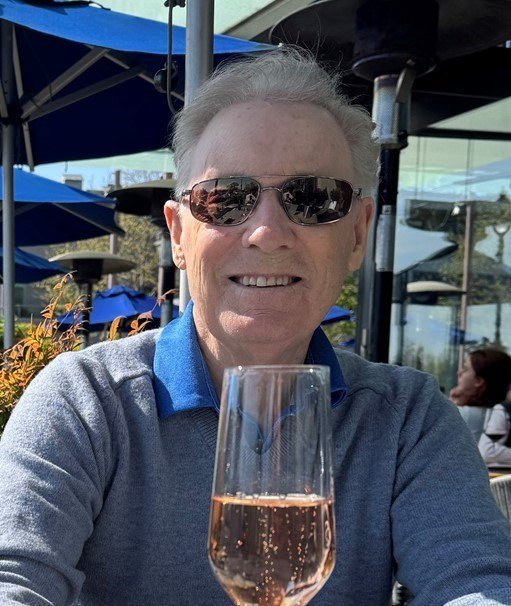 Man enjoying outdoor cafe beverage.