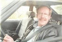 Smiling person driving a car