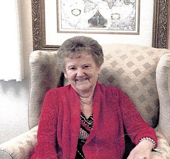 WOODS, Ann (Nancy) Woods Smiling elderly woman in red sitting on chair