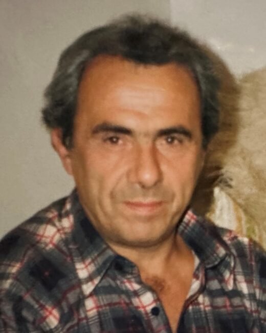 Man in plaid shirt looking at camera