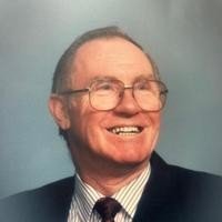 Smiling man in suit with glasses