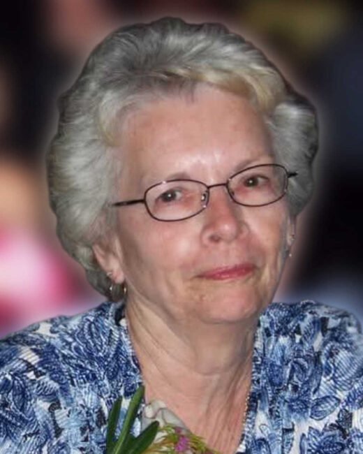 Smiling woman with glasses and floral blouse