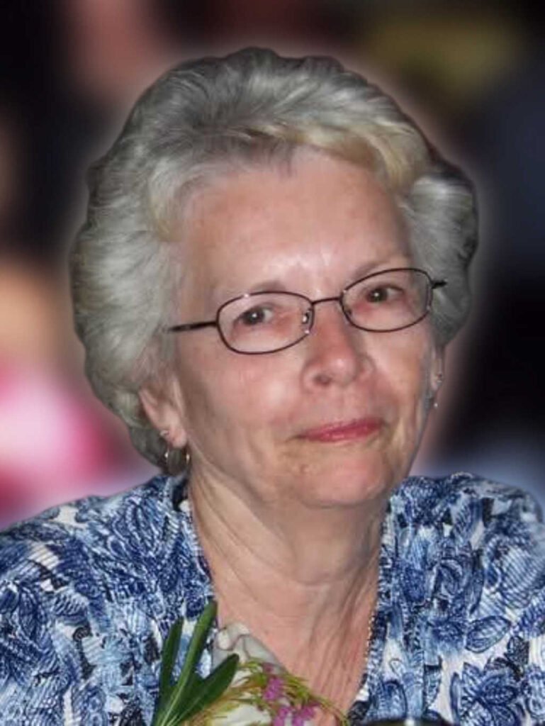 Smiling woman with glasses and floral blouse