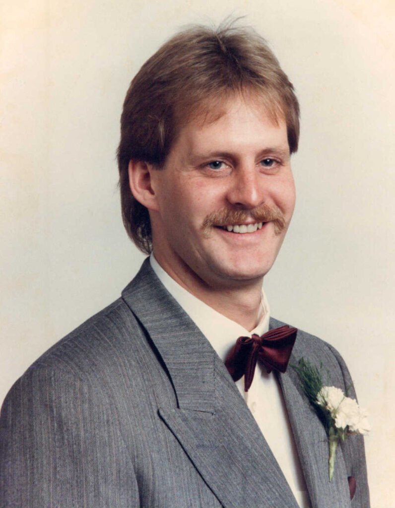Man in gray suit with red bow tie