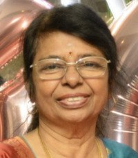 Smiling woman with glasses and traditional attire