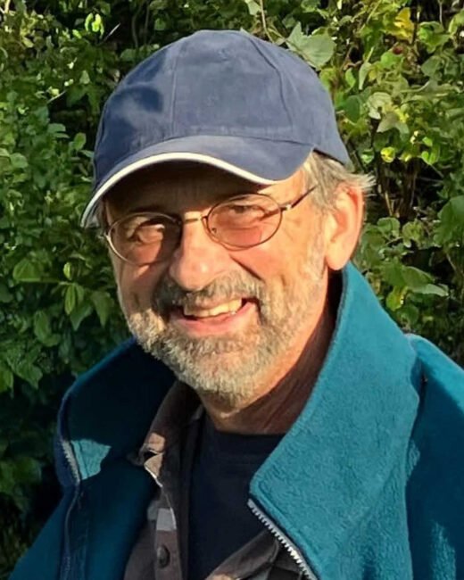Smiling man wearing a blue cap outdoors
