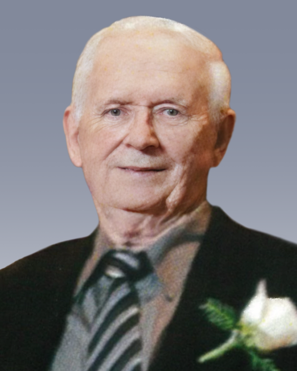 Elderly man wearing suit and tie with white flower.
