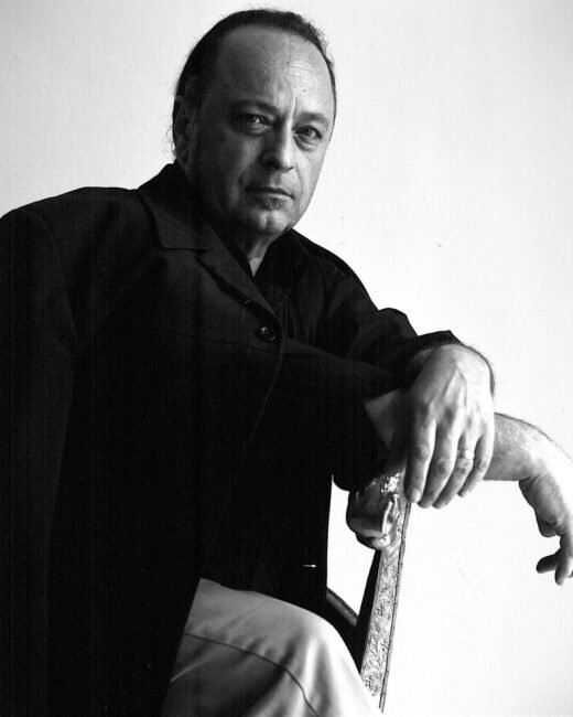 Man sitting in black-and-white photo.
