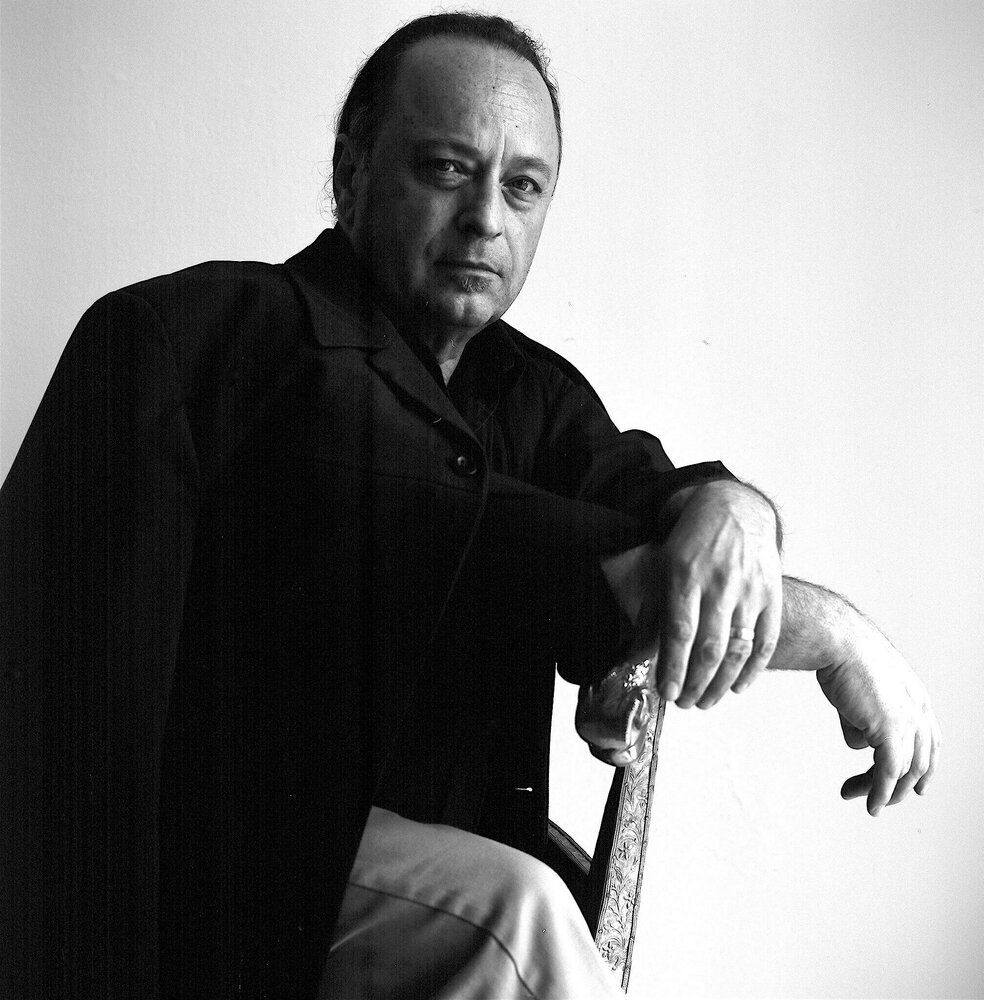 Man sitting in black-and-white photo.
