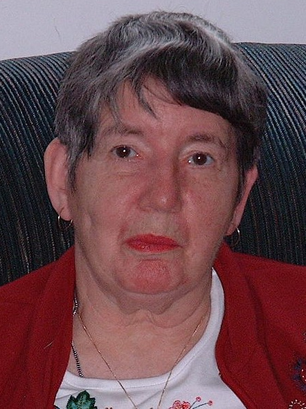 Elderly woman with short gray hair and red lipstick.