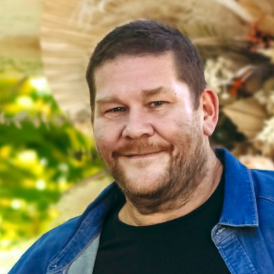 Smiling man with background foliage