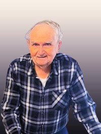 Elderly man in plaid shirt smiling