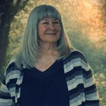 MCCRIMMON, Bonnie Anne McCrimmon Woman smiling outdoors with striped sweater