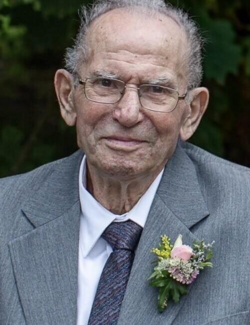 Elderly man in gray suit with boutonniere