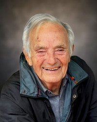 Elderly man smiling in a jacket