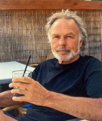 Man relaxing with a drink outdoors.