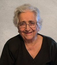 Smiling elderly woman with gray hair and glasses