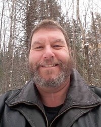 Smiling man in winter forest scene