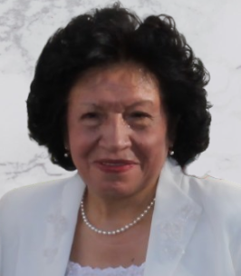 Smiling person in white attire with curly hair