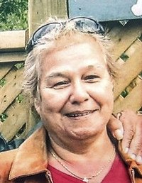 Smiling person with sunglasses on their head