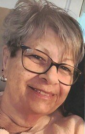 Smiling woman with glasses and gray hair