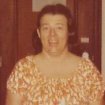 Smiling person in floral dress indoors, vintage photo.
