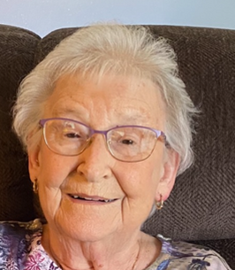 Smiling elderly woman sitting on a couch