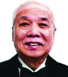 Elderly man smiling in formal attire.