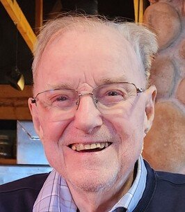 Smiling elderly man with glasses indoors