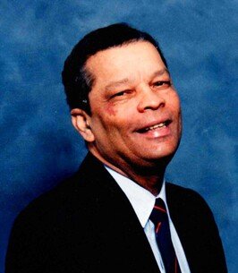 Smiling man in suit against blue background