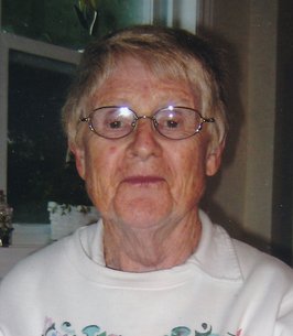 BISHOP, Winnie Bishop Elderly person with glasses in white sweater indoors.