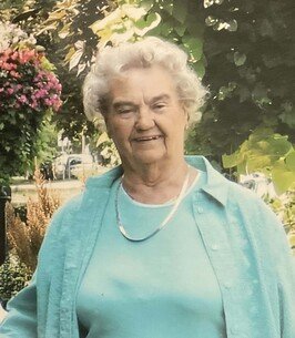 Smiling elderly woman in garden setting