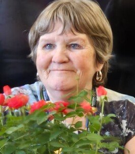Smiling woman with flowers.