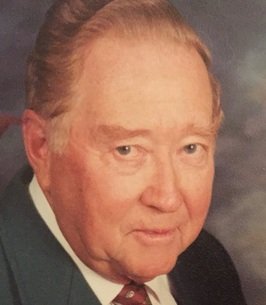 Elderly man in suit with tie, formal portrait.