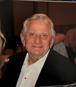 Smiling elderly man at formal event.